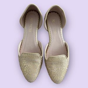 Restricted slip on flats gold and tan.